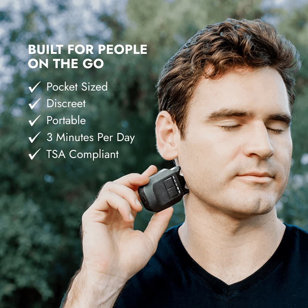 Man using the VeRelief Prime vagus nerve stimulator outdoors, highlighting portable, pocket-sized, and TSA-compliant design for stress relief on the go.