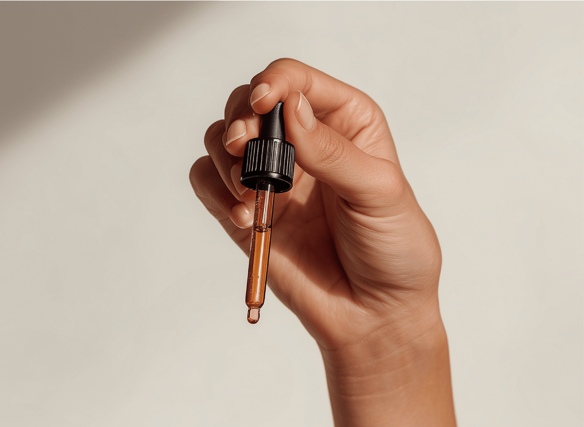 A hand holding an eyedropper of Hoolest Sleep