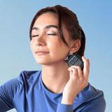 Woman using VeRelief Prime with eyes closed, relaxed